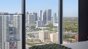 A high-rise building with a view of a cityscape through large windows. - Elevated Experience At The E11EVEN Residences (Miami)