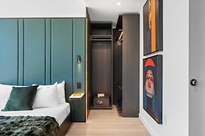 A modern hotel room with a bed, bedside table, and a walk-in closet. - Luxury E11EVEN Adjoining Suites Pool & ELITE Amenities (Miami)