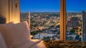 A cityscape view from a window, featuring a mix of residential and commercial buildings, a prominent red building, and a clear sky. - Luxury Downtown Miami Studio with Resort Amenities (Miami)