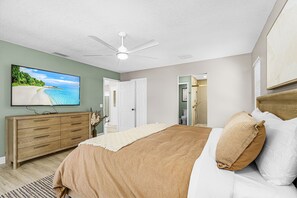 A bedroom with a bed, a dresser, a television, and a ceiling fan. - Gorgeous 4 Bedroom Home with Private Pool and Full Kitchen in Rotonda West (Rotonda West)