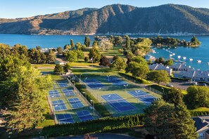 A tennis court complex with multiple courts, surrounded by trees and a lake view. - Wapato Point Family Oasis Sleeps 12 w/Private Buoy, Hot Tub, 6 Bedrooms 5.5 Bath (Manson)