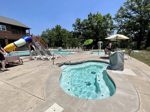 A swimming pool area with a hot tub, lounge chairs, and a slide. - Blue Horizon-Panoramic Lake View on Indian Point (Branson)