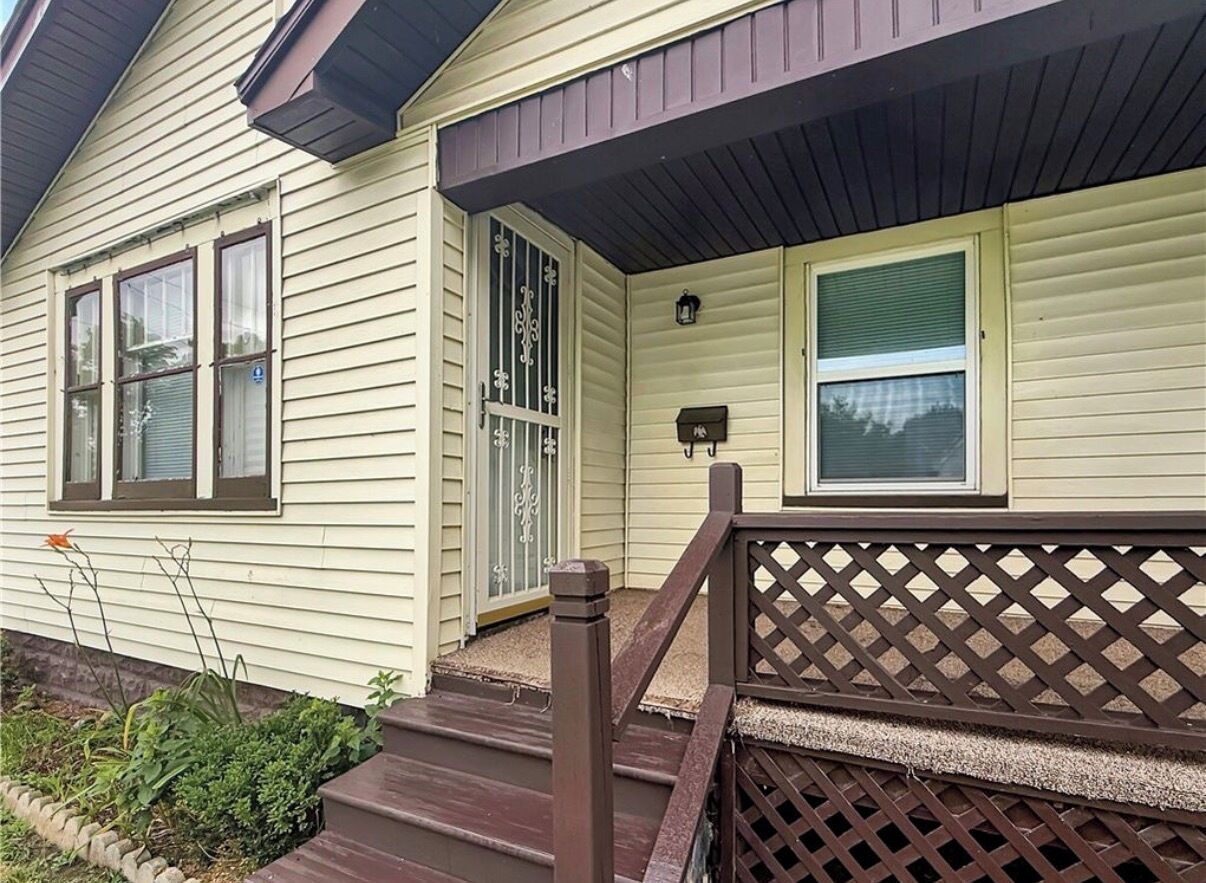 A house with a porch, a front door, and a mailbox.