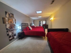 A bedroom with two beds, a nightstand, a lamp, and a ceiling light. - Spacious Home Near Lake, Free Boat Parking (Somerset)