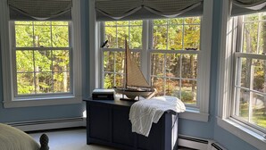 A bedroom with a bed, a dresser, and a sailboat model. - Beautiful home in desirable Riverlocks neighborhood, walkable to Kennebunkport (Kennebunk)