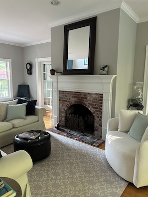 A living room with a fireplace, two sofas, a coffee table, and a patterned rug. - Beautiful home in desirable Riverlocks neighborhood, walkable to Kennebunkport (Kennebunk)