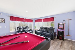 A pool room with a pool table, two leather sofas, a pool cue rack, and a video game machine. - Natures Escape - Game Room, Spa, Sauna, OMG Views! (Escondido)