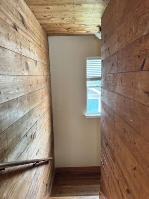 Ein Holzkamin mit Fenster, Treppe und Tür.