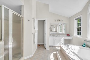 A bathroom with a walk-in shower, a bathtub, a vanity with a mirror, and a window. - Private Oasis Retreat with a Pool (Unknown)