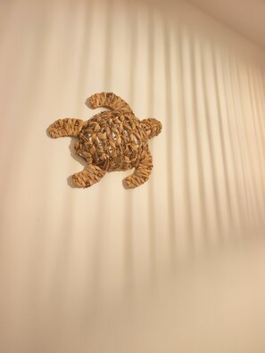 Un objet décoratif en forme de tortue, destiné à être fixé au mur.