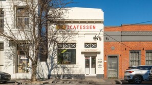 A building with a sign that reads 'EAT IN OR TAKEAWAY' and 'WELCOME TO MISSION DISTRICT.' - Elmrise in Elsternwick (Saint Kilda East)