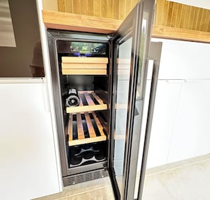 A compact refrigerator with a wooden shelf and a water dispenser.