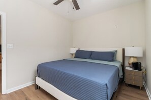 A bedroom with a bed, bedside tables, a ceiling fan, and a nightstand. - Family & Pet-Friendly 3BR, 2BA Ranch Near Horse Park, UK & Downtown (Lexington)