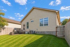 A single-story house with a sloped roof, a fenced backyard, and a patio area with outdoor furniture. - Family & Pet-Friendly 3BR, 2BA Ranch Near Horse Park, UK & Downtown (Lexington)
