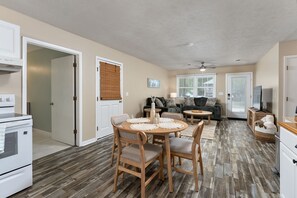 A compact living space with a dining area, kitchenette, and seating area. - Pet-Friendly Oak Island Home W/ Fenced Yard &Fire Pit (Oak Island)