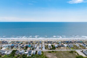 A coastal residential area with houses, a beach, and the ocean. - Pet-Friendly Oak Island Home W/ Fenced Yard &Fire Pit (Oak Island)