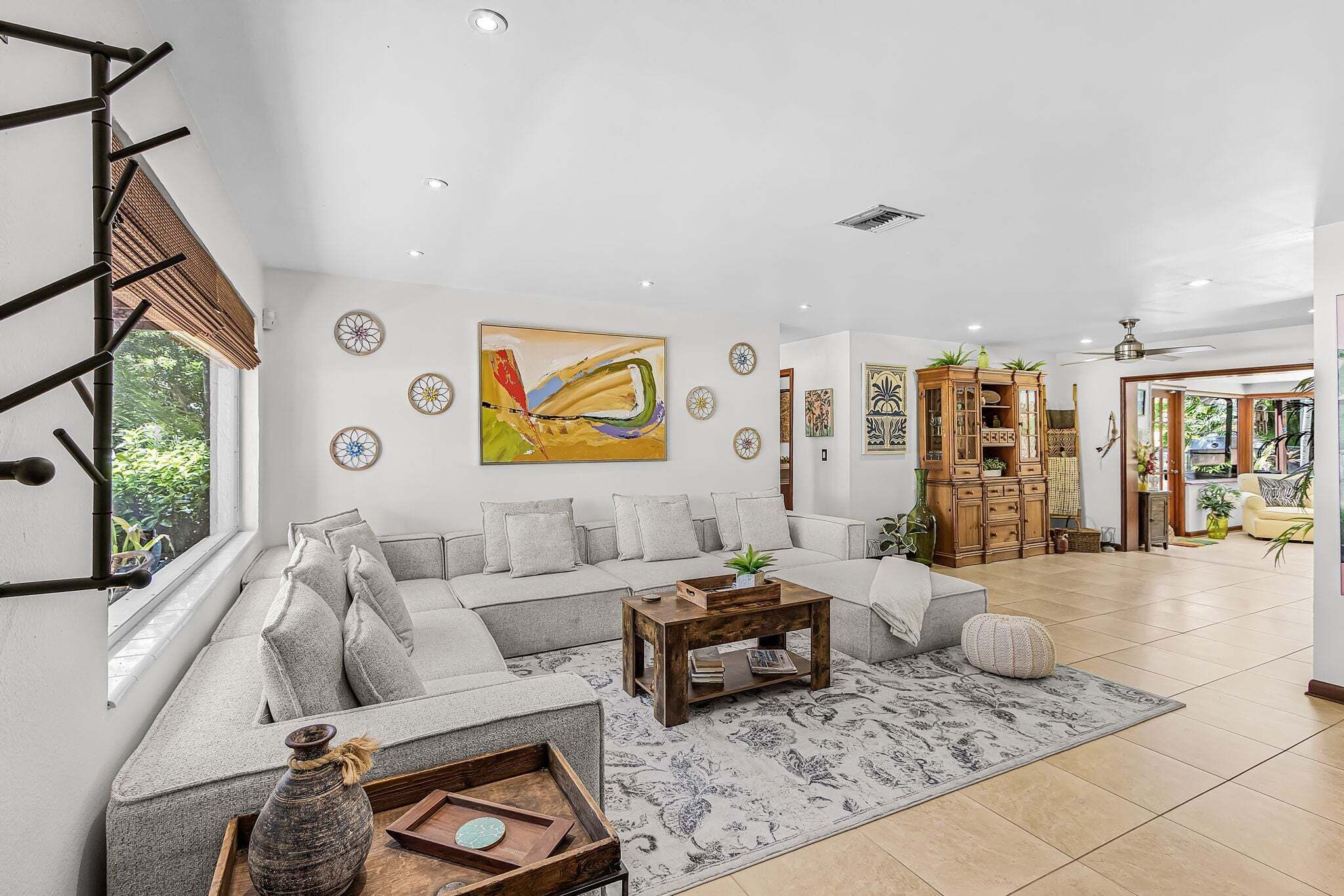 A spacious living room with a large sofa, a coffee table, and decorative items.
