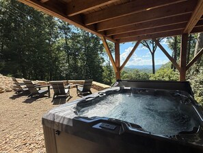 A hot tub under a wooden pergola with a view of a mountainous landscape. - Camp Shady Pines | Luxury Blue Ridge Mountain Retreat (Transylvania County)