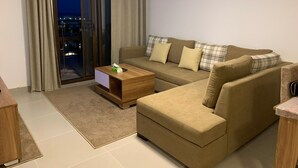 A modern living room with a sofa, a coffee table, and a view through a sliding glass door. - 
    Marassi Marina 1 Sea View (Marsa Matrouh)