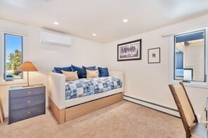 A bedroom with a bed, bedside table, lamp, and artwork on the wall. - FPX Legacy Lodge - One of a kind & Renovated! ~Ski In/Out~  Private HT, Club Amenities & EZCancel (Steamboat Springs)