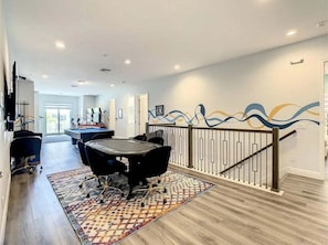 A modern interior with a dining area, a staircase, and a wall with abstract art. - The Reserve at Reunion-TT492 (Kissimmee)