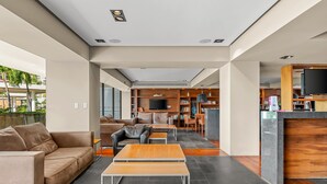 A modern lobby with a sofa, coffee table, and a reception desk. - 1BR, 2BA condo in Marina Vallarta, Puerto Vallarta. (Puerto Vallarta)