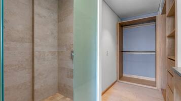 A bathroom with a shower, a toilet, and a sink.