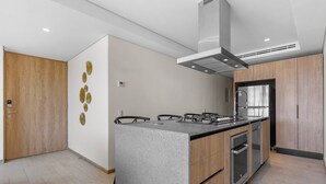A modern kitchen with a central island, built-in oven, and stainless steel appliances. - 1BR, 2BA condo in Marina Vallarta, Puerto Vallarta. (Puerto Vallarta)