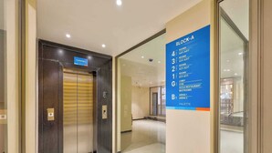 An elevator with a sign indicating 'Elevator A' and a blue directory sign listing rooms and amenities in Block-A. - Palette Hotel Millennium City Gurugram (Gurugram)