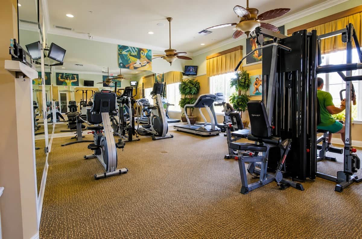 A gym with various exercise equipment, including treadmills and weight machines.