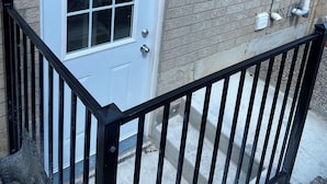 A white door with a window, a brick wall, and a black metal railing. - Entire home in Brampton, Canada
2 guests1 bedroom1 bed1 bath (Brampton)