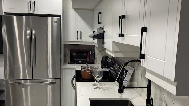 A modern kitchen with stainless steel appliances, white cabinetry, and a marble countertop. - Entire home in Brampton, Canada
2 guests1 bedroom1 bed1 bath (Brampton)