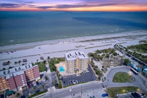 An aerial view of a beachfront hotel with a swimming pool, parking area, and beach access. - Sugar Sand Beachfront Condo, Spectacular Gulf Views, 24' Lanai, 2BR/2BA, #433 (Fort Myers Beach)
