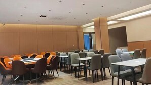A conference room with multiple tables and chairs, a high ceiling with recessed lighting, and a neutral color scheme. - Libo Daqikong Bamboo Garden Boutique Hotel (East Gate Ticket Hall Store of Xiaoqikong Scenic Area) (Libo)