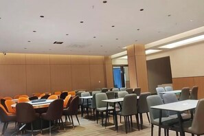 A conference room with multiple tables and chairs, a high ceiling with recessed lighting, and a neutral color scheme. - Libo Daqikong Bamboo Garden Boutique Hotel (East Gate Ticket Hall Store of Xiaoqikong Scenic Area) (Libo)