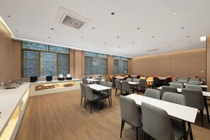 A modern dining area with tables and chairs, large windows, and a counter with a display.