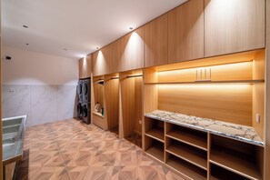 A modern kitchen with wooden cabinets, built-in appliances, and a marble countertop.
