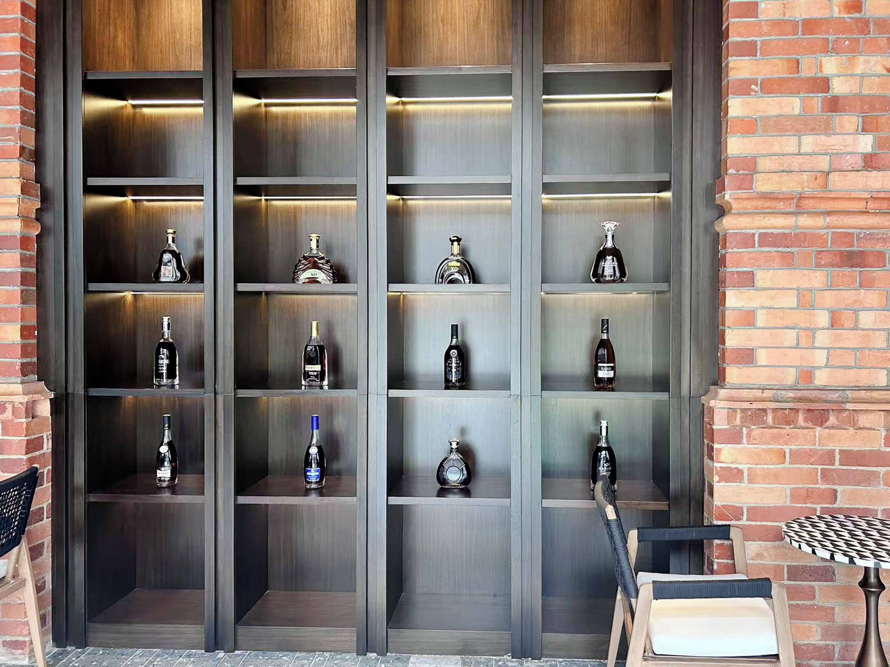 A wall of shelves with various bottles, likely for sale or display.