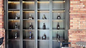 A wall of shelves with various bottles, likely for sale or display.