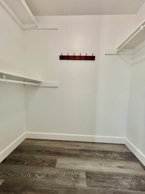 A room with a wooden floor, white walls, and a coat rack with hooks. - Spacious 5BR Pet-Friendly Retreat on a 14,000 Sq Ft Lot (Stockton)