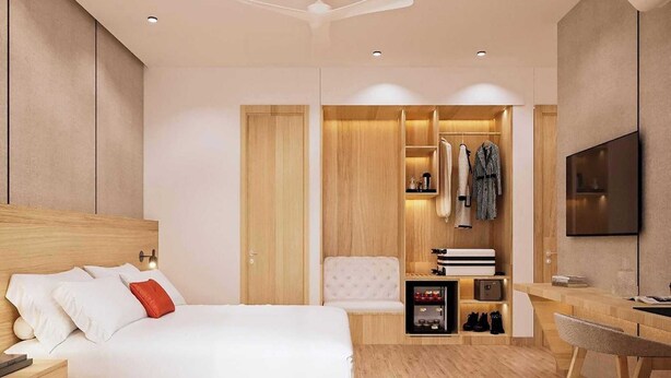 A modern hotel room with a bed, bedside table, wardrobe, and a desk with a chair. - Palette Convention Hotel Millennium City (Gurugram)
