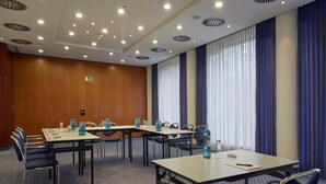 A conference room with a long table, chairs, and a patterned carpet. - 3 Person Holiday Park Home in Kassel (Kassel)