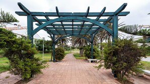 A pathway leading to a green pergola structure. - Exceptional Villa with Pool, Jacuzzi, and Sauna—2 Minutes from the Beach (Dar Bouazza)