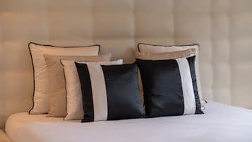 A bed with a headboard and three pillows.