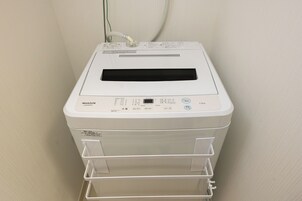 A white MAXZEN printer with a control panel, a paper tray, and a power cord.