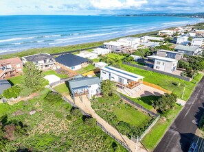 A residential area with houses, a road, and a beach in the background. - Sea Break - Middleton Beach Holiday House with Ocean View (Middleton)