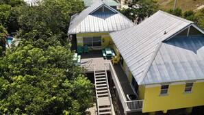 A coastal property with multiple buildings, a dock, and a view of the ocean. - Heart of the Key Cottage (Marathon)