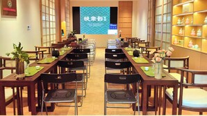 A conference room with tables and chairs arranged for a meeting.
