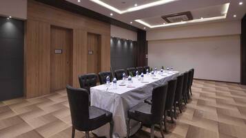 A conference room with a long table, chairs, and water bottles.