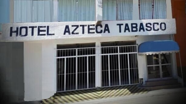 A multi-story building with a sign reading 'HOTEL AZTECA TABASCO'.